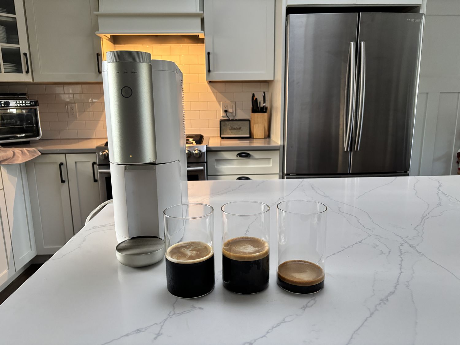 The Cumulus machine beside three glasses of cold brew.